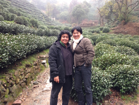 Sophia and Hua standing in a green tea plantation in Eastern China